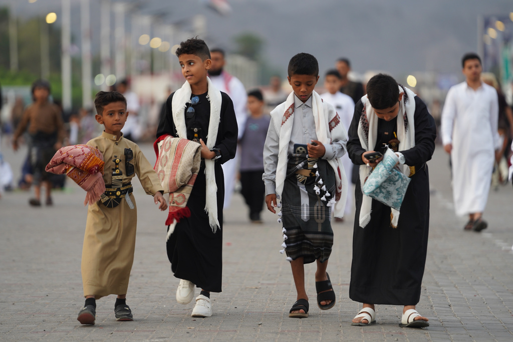 People walk to pray Eid Al-Fitr prayers, marking the feast after Ramadan, celebrating the end of fasting, in Aden, Yemen, Friday, March 20, 2026. (AP Photo/Abdulnasser Alseddik)