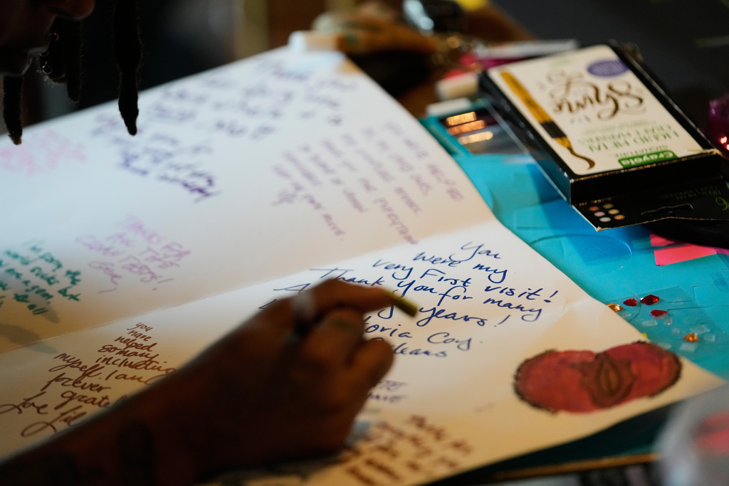 Members of Louisiana Coalition for Reproductive Freedom compose thank you cards and well wishes at a coffee shop to deliver to Planned Parenthood on the day they are closing, in New Orleans, Tuesday, Sept. 30, 2025. (AP Photo/Gerald Herbert)