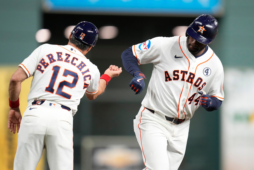 Houston Astros designated hitter Yordan Alvarez, right, celebrates his two-run home run with third base coach Tony Perezchica (12) during the first inning of a baseball game against the Pittsburgh Pirates, Tuesday, June 2, 2026, in Houston. (AP Photo/Karen Warren)