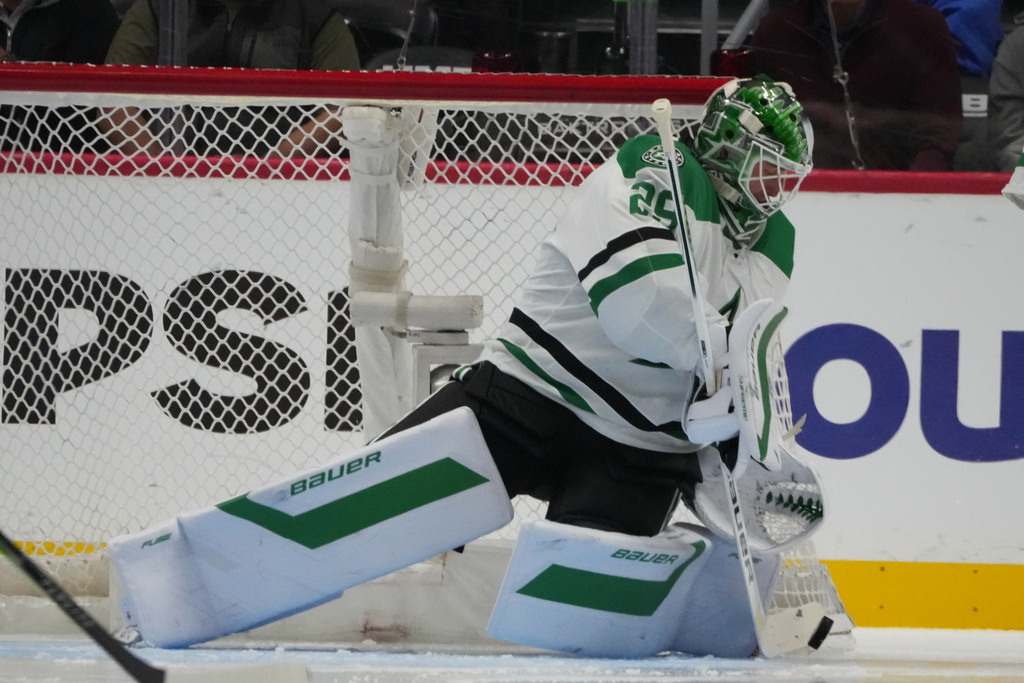 Dallas Stars goaltender Jake Oettinger makes a stick save in the second period of an NHL hockey game against the Colorado Avalanche Wednesday, March 18, 2026, in Denver. (AP Photo/David Zalubowski)