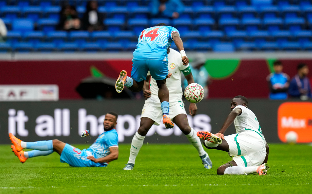 DR Congo's Noah Sadiki is challenged by Senegal's Kalidou Koulibaly during the Africa Cup of Nations group D soccer match between Senegal and DR Congo in Tangier, Morocco, Saturday, Dec. 27, 2025. (AP Photo/Themba Hadebe)