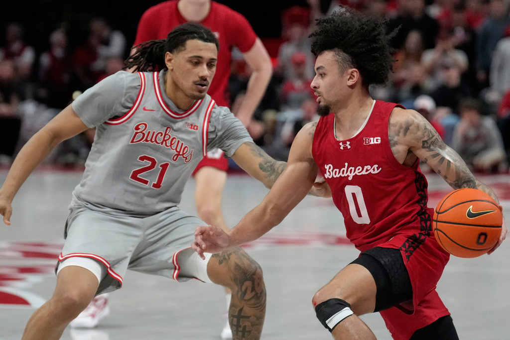 Wisconsin guard Braeden Carrington (0) drives against Ohio State forward Devin Royal (21) in the first half of an NCAA college basketball game Tuesday, Feb. 17, 2026, in Columbus, Ohio. (AP Photo/Sue Ogrocki)