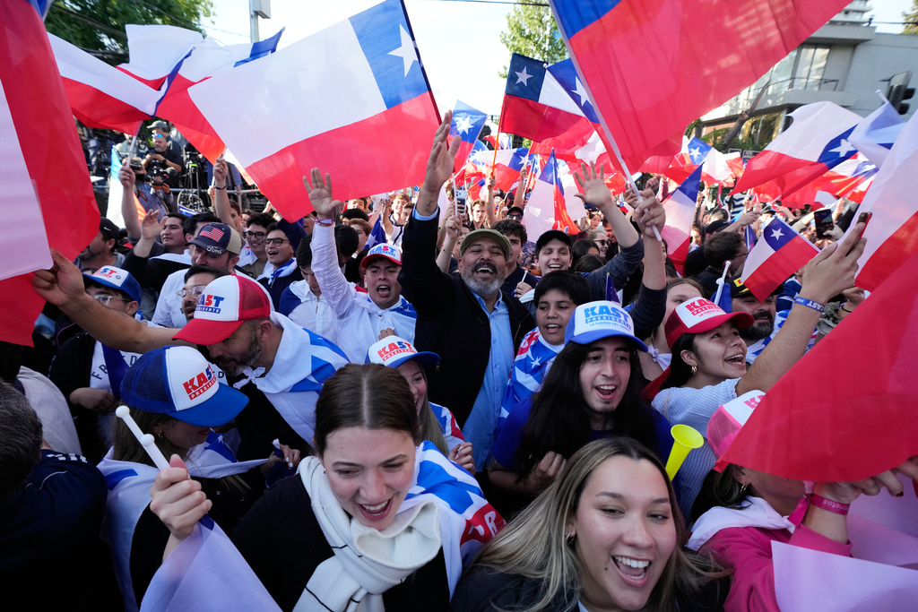 Supporters of Jose Antonio Kast, presidential candidate of the opposition Republican Party, celebrate preliminary results after polls closed for a presidential runoff election in Santiago, Chile, Sunday, Dec. 14, 2025. (AP Photo/Esteban Felix)