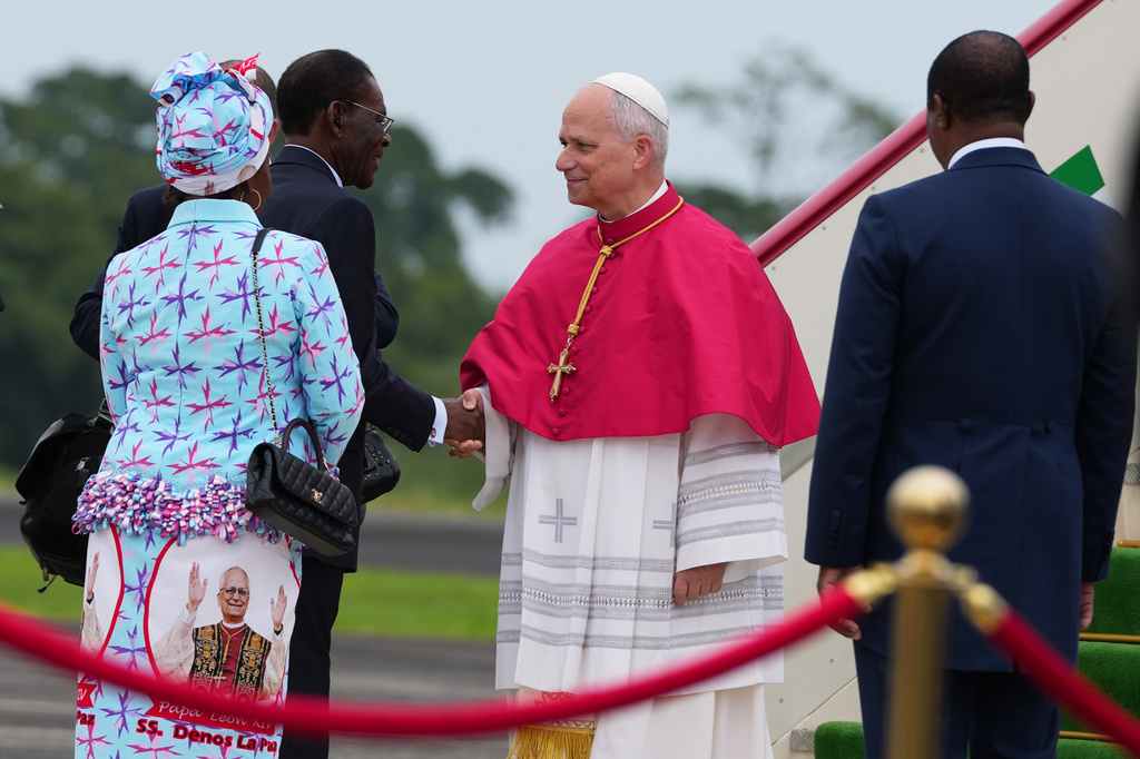 Pope Leo XIV is welcomed by Equatorial Guinea's President Teodoro Obiang Nguema Mbasogo, second left, upon his arrival at Malabo International Airport in Malabo, Equatorial Guinea, Tuesday, April 21, 2026, on the ninth day of his 11-day pastoral visit to Africa. (AP Photo/Misper Apawu)