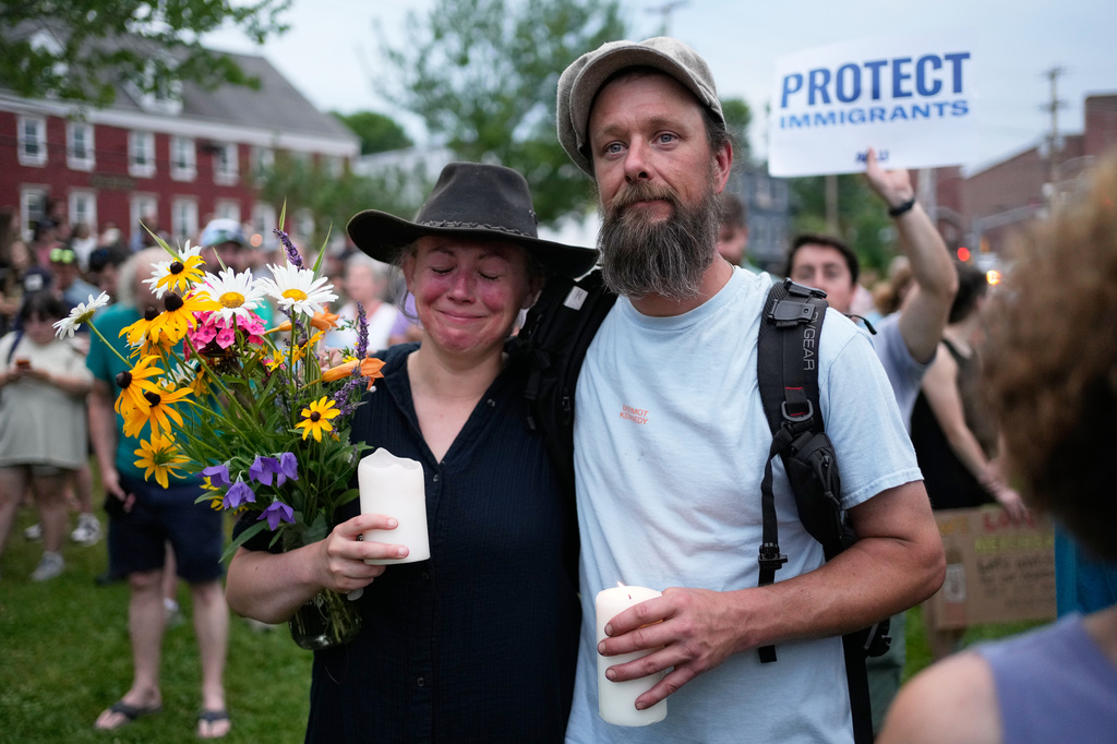 Attendees stand during a vigil after a man was shot and killed by U.S. Immigration and Customs Enforcement on Monday, July 13, 2026, in Biddeford, Maine. (AP Photo/Robert F. Bukaty)