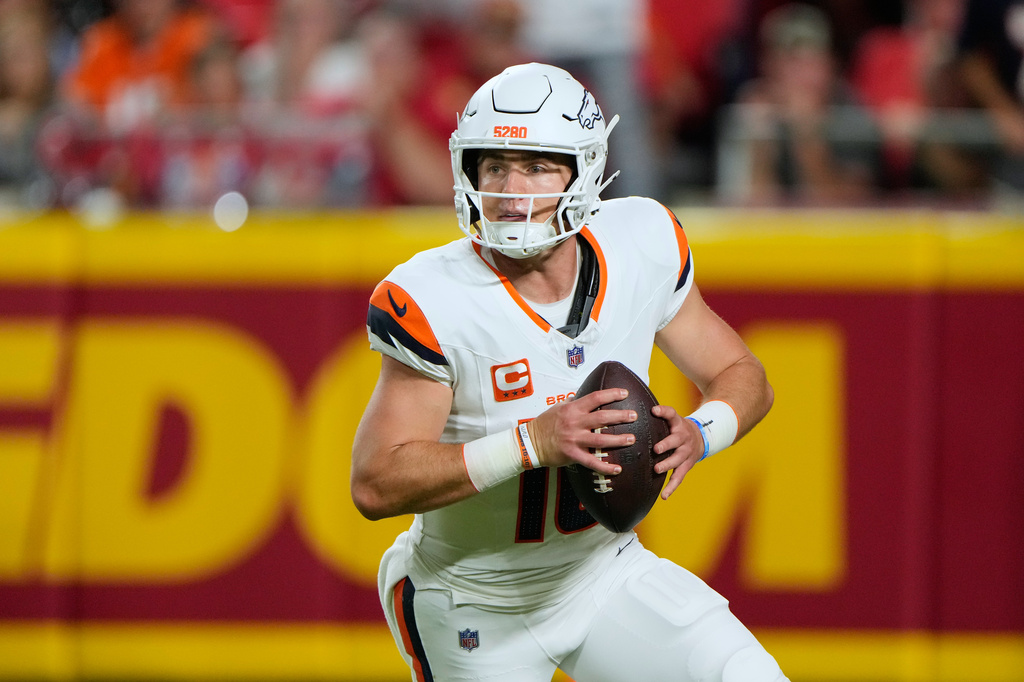 Denver Broncos quarterback Bo Nix rolls out looking to pass against the Kansas City Chiefs during the first half of an NFL football game Monday, Sept. 14, 2026, in Kansas City, Mo. (AP Photo/Charlie Riedel)