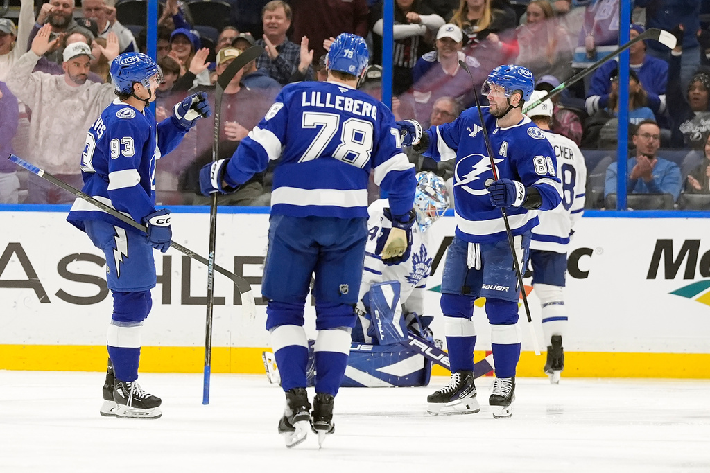 Tampa Bay Lightning right wing Nikita Kucherov (86) celebrates his goal against the Toronto Maple Leafs with center Gage Goncalves (93) and defenseman Emil Lilleberg (78) during the third period of an NHL hockey game Wednesday, Feb. 25, 2026, in Tampa, Fla. (AP Photo/Chris O'Meara)