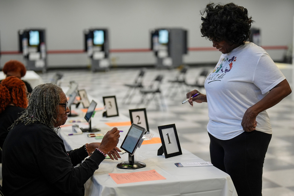 A woman speaks to a Fulton County Election worker before she votes in a runoff election at the C.T. Martin Recreation Center, Tuesday, June 16, 2026, in Atlanta. (AP Photo/Mike Stewart)
