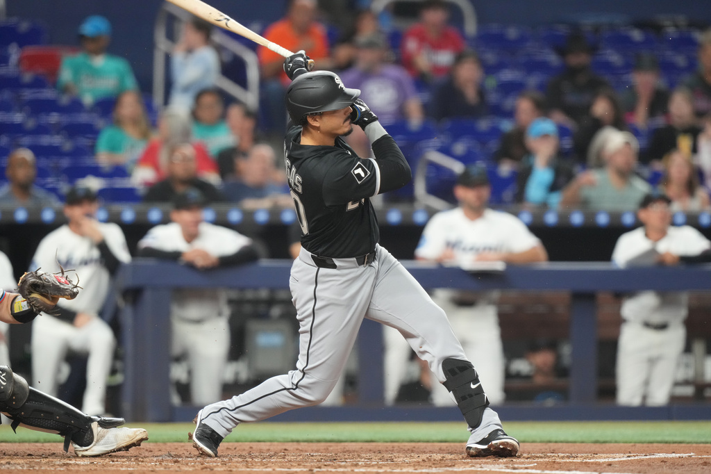 Chicago White Sox Miguel Vargas (20) hits a single to left field during the third inning of baseball game against the Miami Marlins Monday, March 30, 2026, in Miami. (AP Photo/Marta Lavandier)
