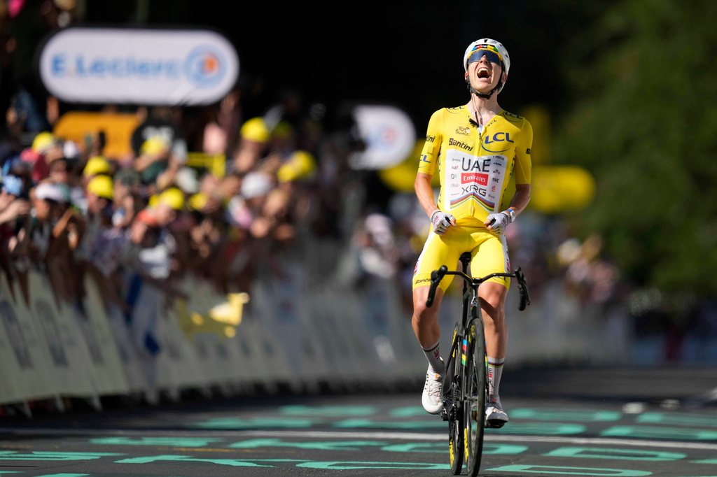 Slovenia's Tadej Pogacar, wearing the overall leader's yellow jersey, celebrates after winning the tenth stage of the Tour de France cycling race with start in Aurillac and finish in Le Lioran, France, Tuesday, July 14, 2026. (AP Photo/Mosa'ab Elshamy)