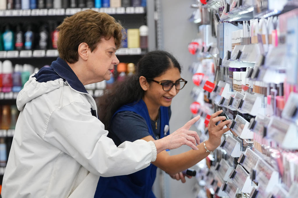 Priyanka Patil, right, fashion team lead at Walmart, helps Linda Flippin, of Colleyville, Texas, find a makeup item on the shelves near the store's beauty counter, Wednesday, April 29, 2026, in Grapevine, Texas. (AP Photo/Julio Cortez)