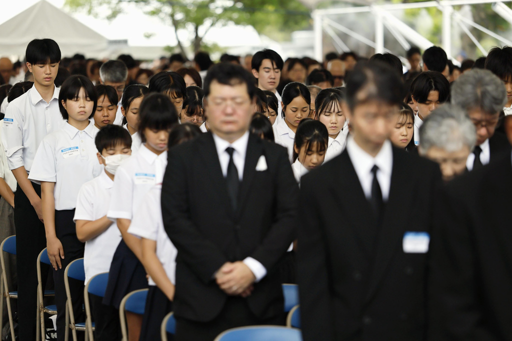 People observe a minute of silence during a ceremony to mark the 81st anniversary of the U.S. atomic bombing at the Peace Park in Nagasaki, southern Japan Sunday, Aug. 9, 2026. (Taichi Nagahisa/Kyodo News via AP)