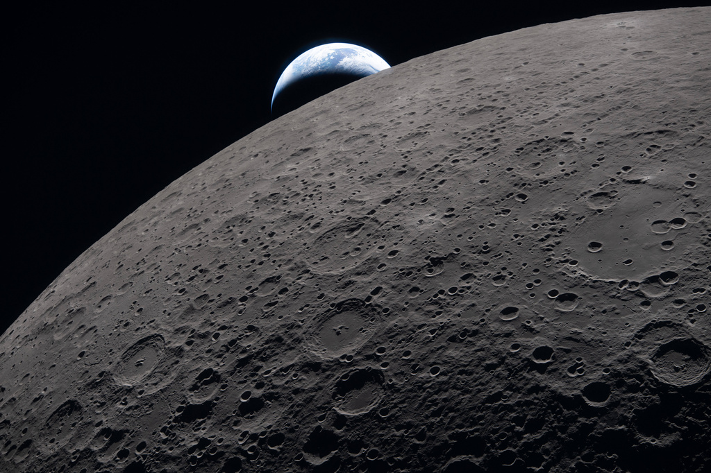 In this image provided by NASA, the Artemis II crew captured this view as the Earth sets behind the Moon during a lunar flyby, Monday, April 6, 2026. (NASA via AP)