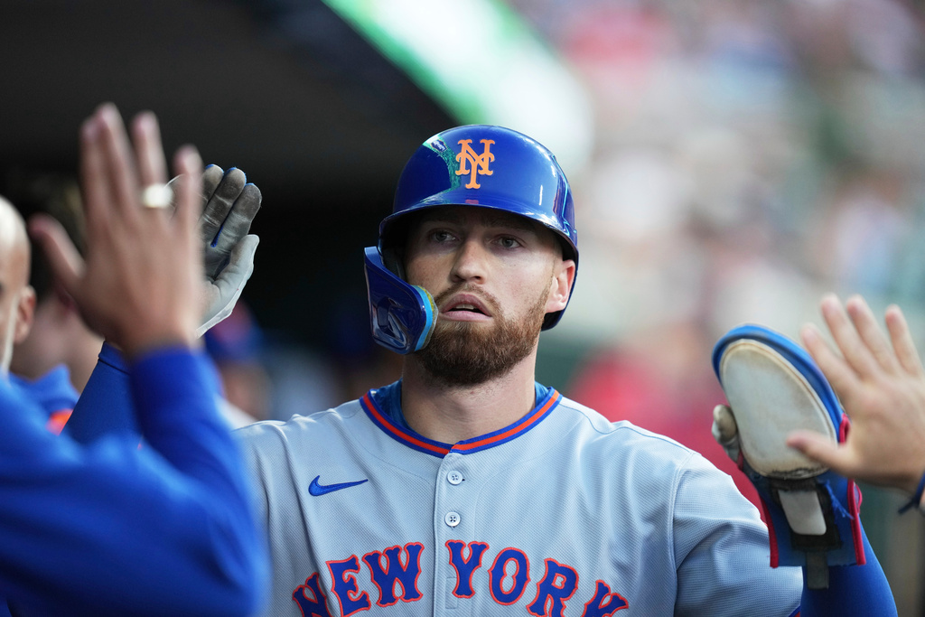 FILE - New York Mets' Brandon Nimmo celebrates in the dugout after scoring off of a sacrifice fly by Cedric Mullins during the fourth inning of a baseball game against the Detroit Tigers, Tuesday, Sept. 2, 2025, in Detroit. (AP Photo/Ryan Sun, File)