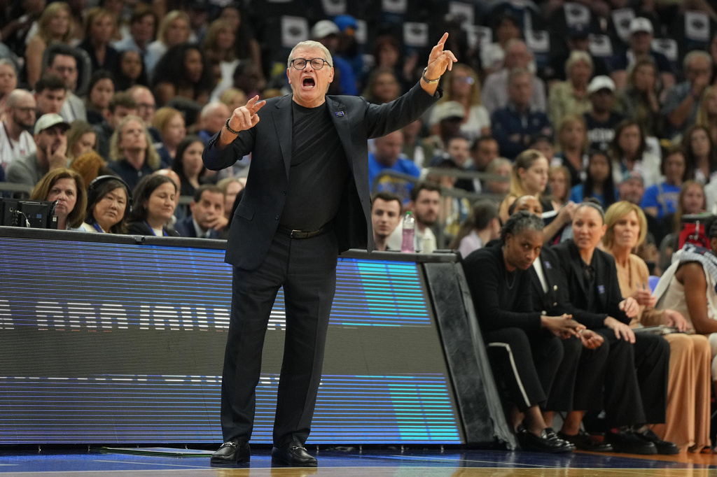 UConn head coach Geno Auriemma motions towards the court during the first half of a woman's NCAA college basketball tournament semifinal game between UConn and South Carolina at the Final Four, Friday, April 3, 2026, in Phoenix. (AP Photo/Rick Scuteri)