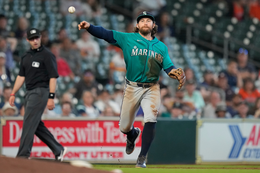 Seattle Mariners third baseman Brendan Donovan throws to first to out Houston Astros' Jose Altuve during the seventh inning of a baseball game in Houston, Thursday, May 14, 2026. (AP Photo/Ashley Landis)