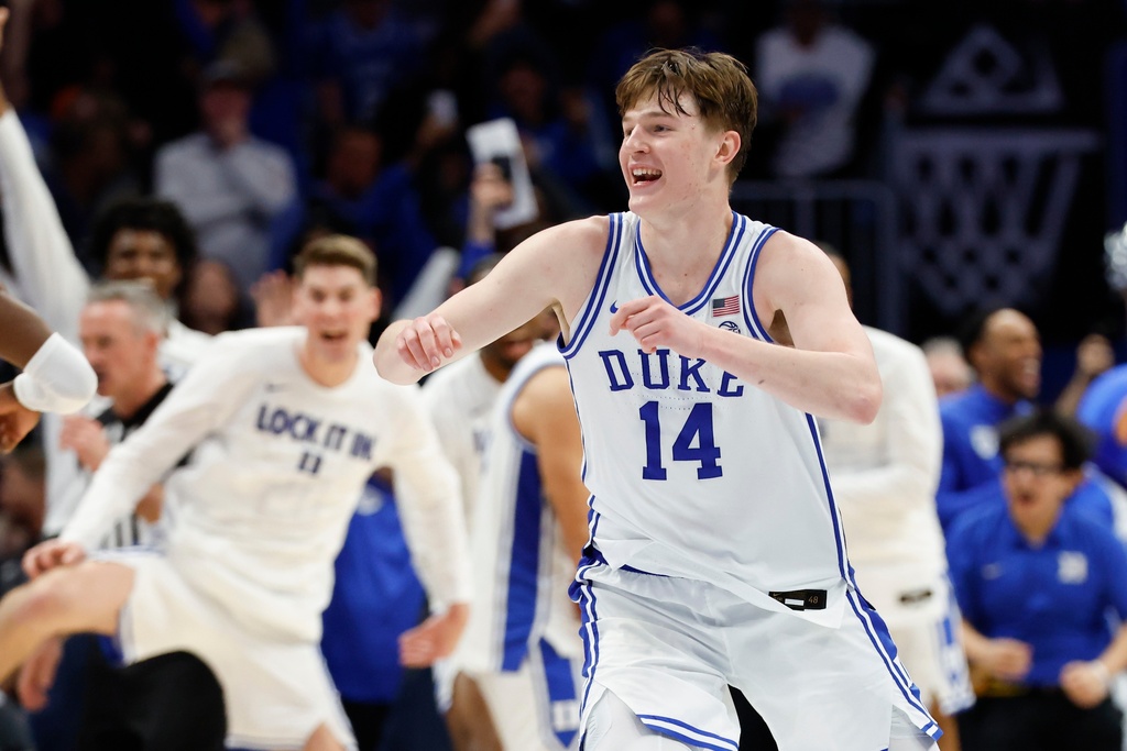 Duke guard Nikolas Khamenia (14) celebrates as Duke defeats Virginia in an NCAA college basketball game in the championship of the Atlantic Coast Conference tournament in Charlotte, N.C., Saturday, March 14, 2026. (AP Photo/Nell Redmond)