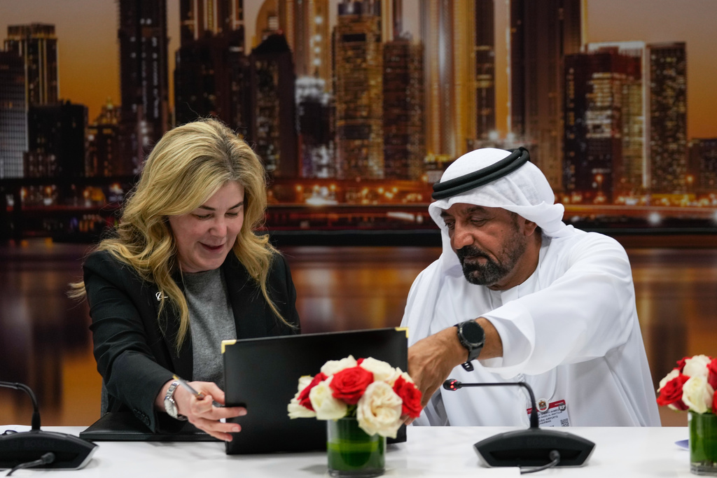 Stephanie Pope, President and CEO of Boeing Commercial Airplanes, left, and Sheikh Ahmed bin Saeed Al Maktoum, President, Dubai Civil Aviation Authority and Chairman of Emirates airlines, sign an agreement to order 65 additional Boeing 777X aircrafts during a press conference on the opening day of the Dubai Air Show, United Arab Emirates, Monday, Nov. 17, 2025. (AP Photo/Altaf Qadri)