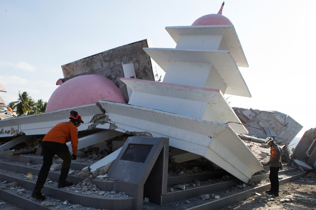 Rescuers inspect the ruins of a mosque that collapsed during an earthquake in North Lamba Leda, East Nusa Tenggara province, Indonesia, Tuesday, Aug. 18, 2026. (AP Photo/Firdia Lisnawati)