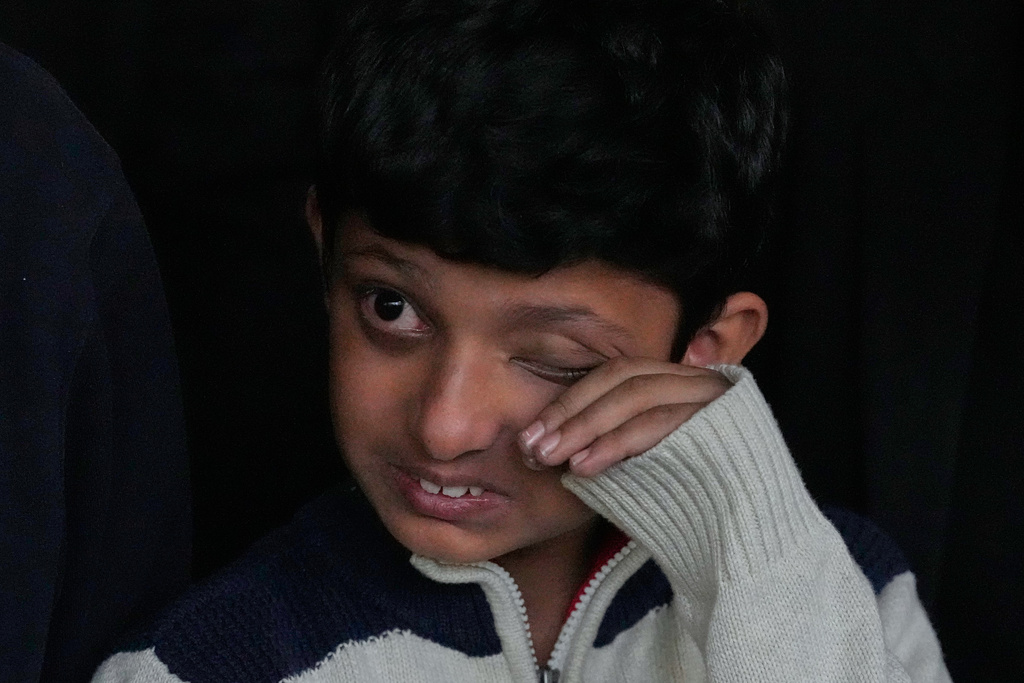 Yahya Zubair, son of lawyer Zubair Aslam Ghumman, who was killed in Tuesday's suicide bombing outside the gates of a district court, wipes his tears as he attends his father's funeral prayer, in Islamabad, Pakistan, Wednesday, Nov. 12, 2025. (AP Photo/Anjum Naveed)