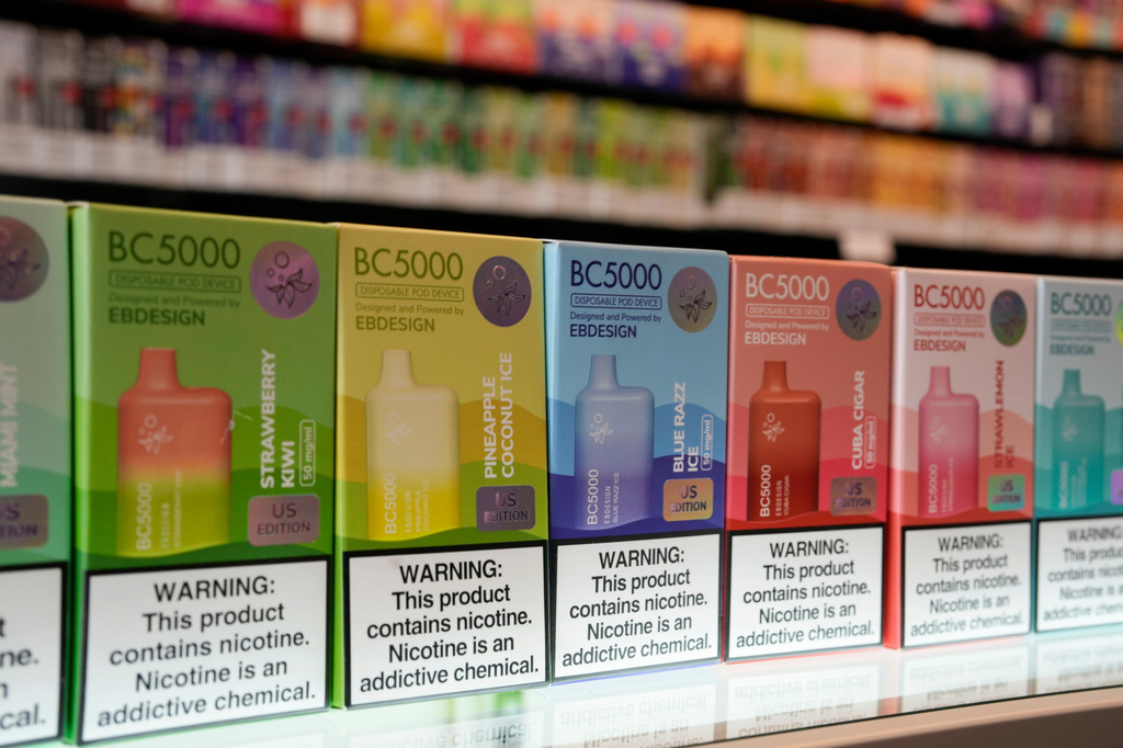 FILE - Varieties of disposable flavored electronic cigarette devices manufactured by EB Design, formerly known as Elf Bar, are displayed at a store in Pinecrest, Fla., June 26, 2023. (AP Photo/Rebecca Blackwell, File)