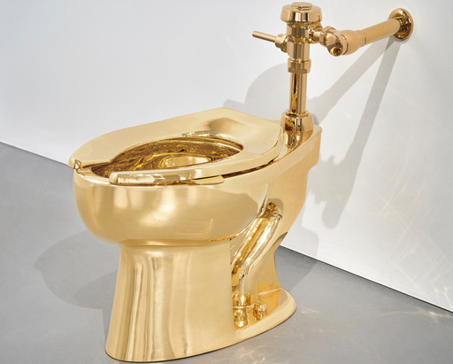 Sotheby’s has announced it will auction a solid gold toilet, a sculpture by Italian artist Maurizio Cattelan called “America.” The auction is set for Nov. 18 in New York. (Sotheby via AP) Sotheby’s has announced it will auction a solid gold toilet, a sculpture by Italian artist Maurizio Cattelan called “America.” The auction is set for Nov. 18 in New York. (Sotheby via AP)