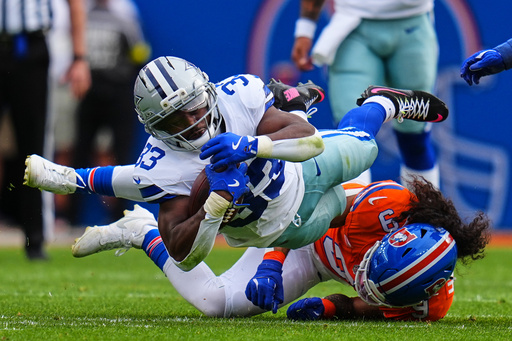 Dallas Cowboys running back Javonte Williams (33) is tackled by Denver Broncos safety Talanoa Hufanga (9) after gaining yards on a run in the first half of an NFL football game Sunday, Oct. 26, 2025, in Denver. (AP Photo/Jack Dempsey) Dallas Cowboys running back Javonte Williams (33) is tackled by Denver Broncos safety Talanoa Hufanga (9) after gaining yards on a run in the first half of an NFL football game Sunday, Oct. 26, 2025, in Denver. (AP Photo/Jack Dempsey)