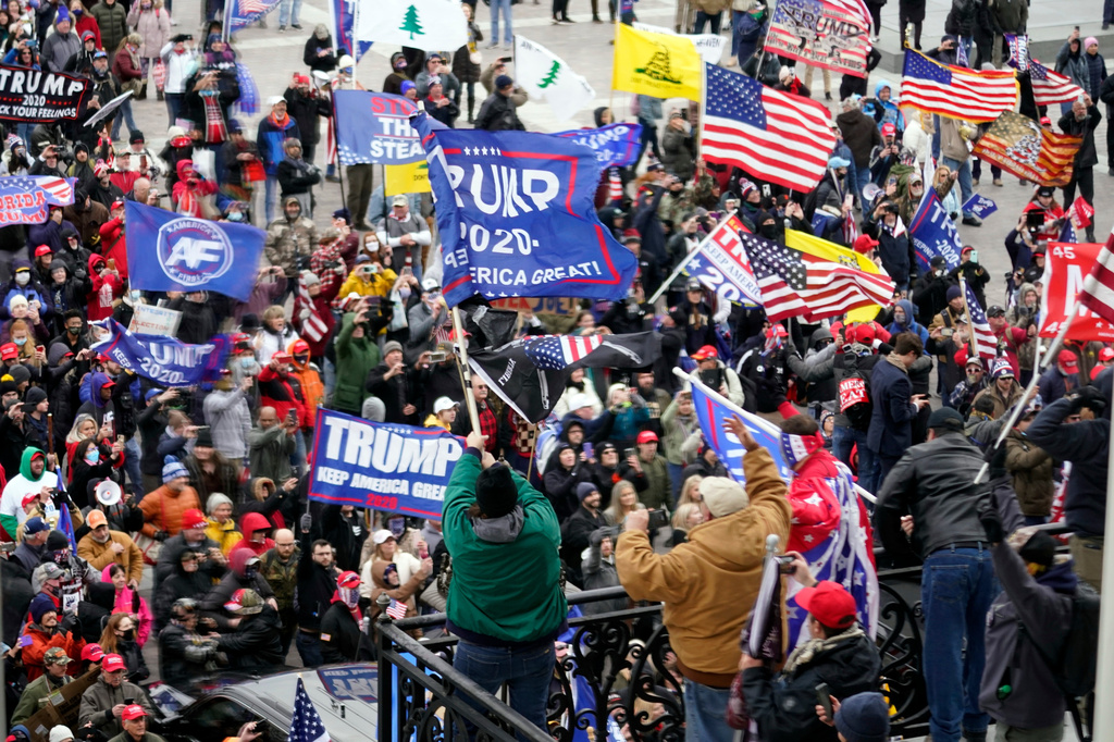 FILE - Violent protesters gather outside the U.S. Capitol, Jan 6, 2021. (AP Photo/Andrew Harnik, File)