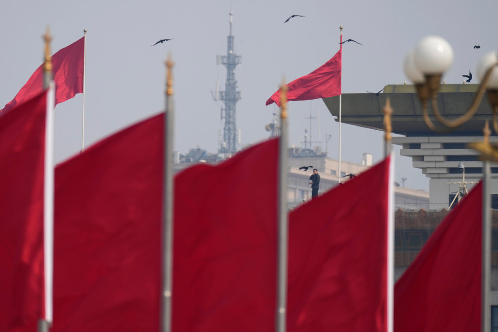 A worker stands on the rooftop near Tiananmen Square before the closing session of the National People's Congress (NPC) at the Great Hall of the People in Beijing, Thursday, March 12, 2026. (AP Photo/Ng Han Guan)