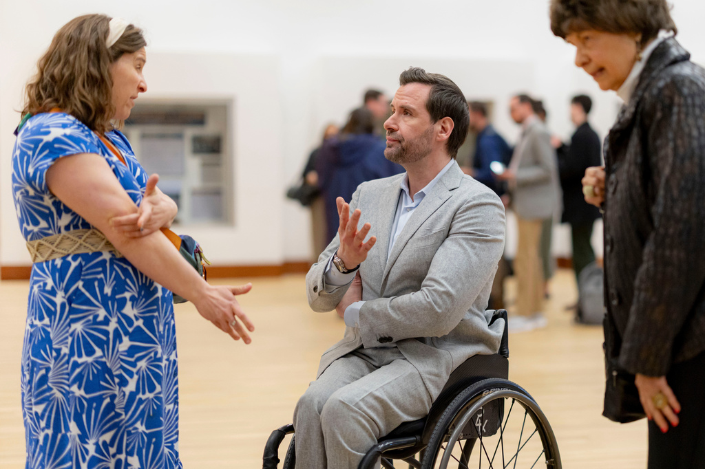 FILE - Iowa state Rep. Josh Turek, center, talks with community members following a candidates forum at the State of Iowa Historical Building in Des Moines, Iowa, April 8, 2026. (Nick Rohlman/The Gazette via AP, File)