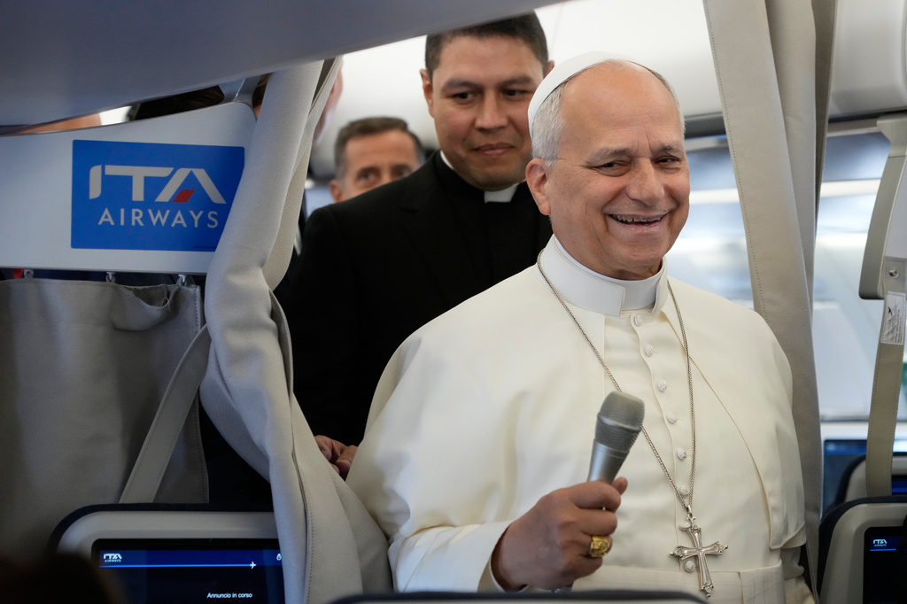 Pope Leo XIV talks to journalists aboard the papal flight from Rome to Paris, Friday, Sept. 25, 2026, during his apostolic journey to France. (AP Photo/Gregorio Borgia, Pool)