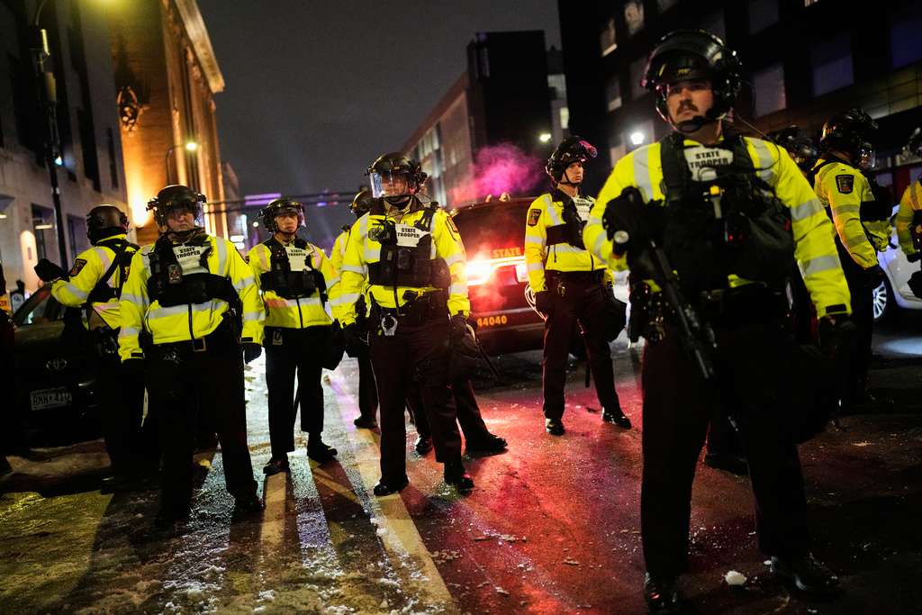 Minnesota State Patrol officers are seen during a protest and noise demonstration calling for an end to federal immigration enforcement operations in the city, Friday, Jan. 9, 2026, in Minneapolis. (AP Photo/John Locher)