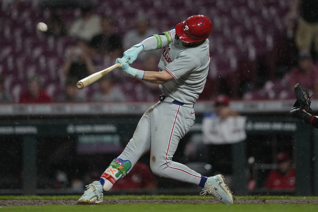 Philadelphia Phillies' Bryce Harper hits a solo home run during the ninth inning of a baseball game against the Cincinnati Reds Tuesday, Aug. 12, 2025, in Cincinnati. (AP Photo/Carolyn Kaster)