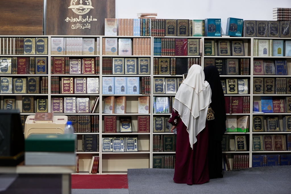 Women search for books at a stall selling Islamic books during the 57th Damascus International Book Fair in Damascus, Syria, Monday, Feb. 16, 2026, the first edition since the collapse of the Assad regime. (AP Photo/Omar Sanadiki)