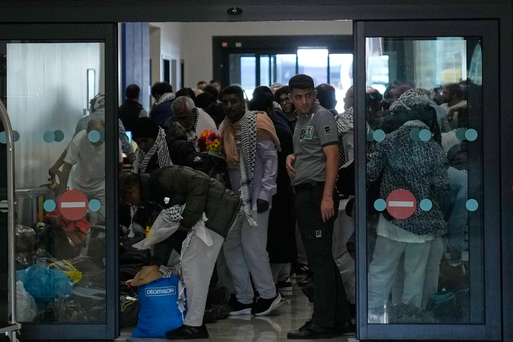 Activists from the Global Sumud Flotilla pick up their luggage after arriving at Istanbul Airport in Istanbul, Turkey, Saturday, Oct. 4, 2025. (AP Photo/Khalil Hamra)