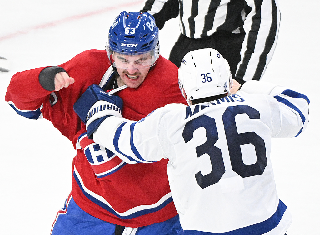 Montreal Canadiens' Florian Xhekaj, right, fights with Toronto Maple Leafs' Dakota Mermis (36) during the third period of an NHL hockey game in Montreal, Saturday, Nov. 22, 2025. (Graham Hughes/The Canadian Press via AP)