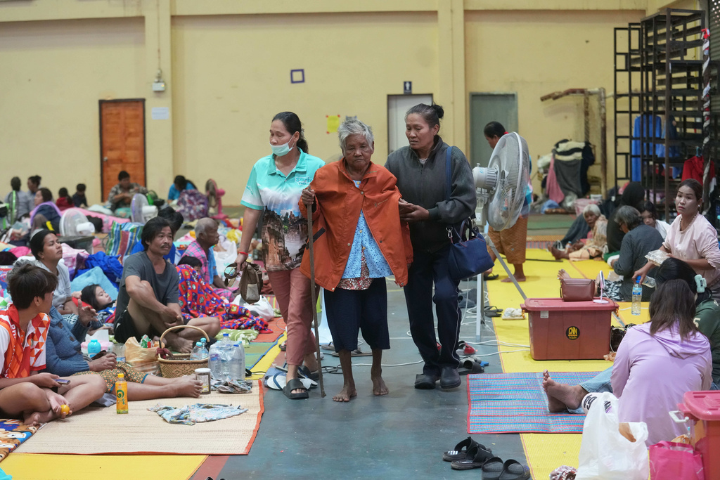 Thai residents who fled homes following the clashes between Thai and Cambodian soldiers, rest at an evacuation center in Surin province, Thailand, Wednesday, Dec. 10, 2025. (AP Photo/Sakchai Lalit)