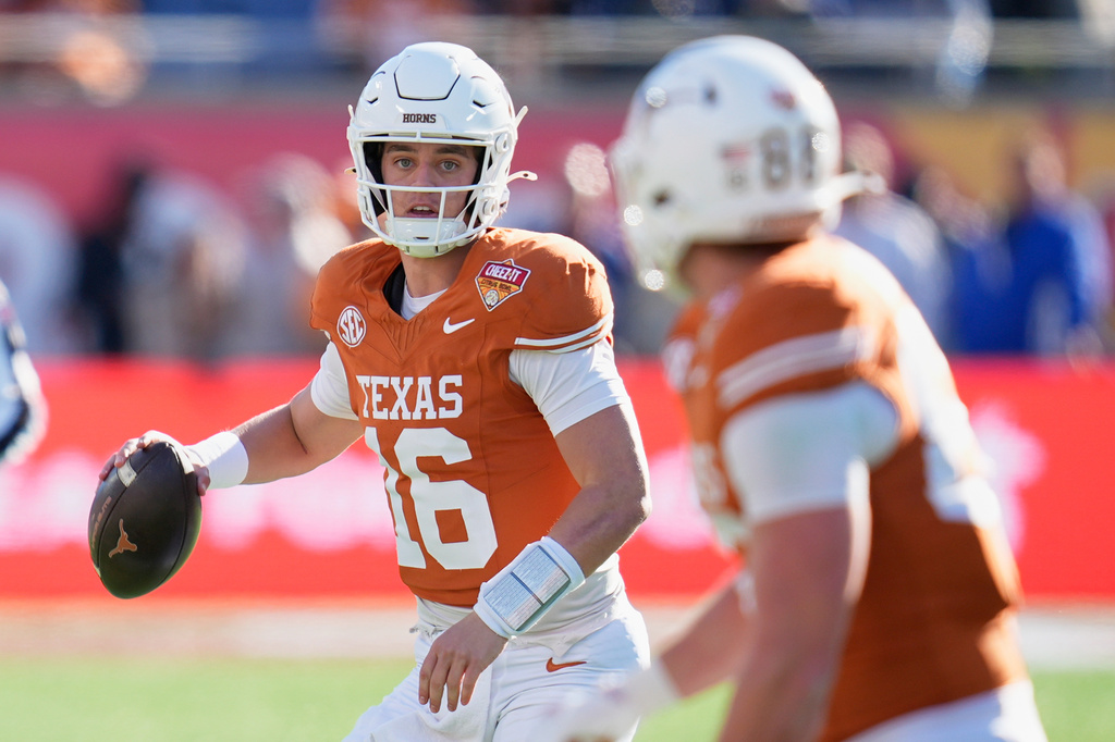 FILE - Texas quarterback Arch Manning (16) looks for a receiver during the first half of the Citrus Bowl NCAA college football game against Michigan, Dec. 31, 2025, in Orlando, Fla. (AP Photo/John Raoux, File)
