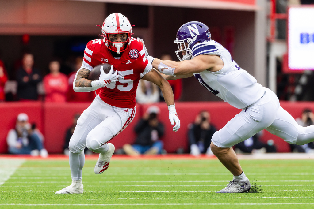 Nebraska running back Mekhi Nelson (35) carries the ball past Northwestern defensive lineman Aidan Hubbard (91) during the first half of an NCAA college football game, Saturday, Oct. 25, 2025, in Lincoln, Neb. (AP Photo/Bonnie Ryan)