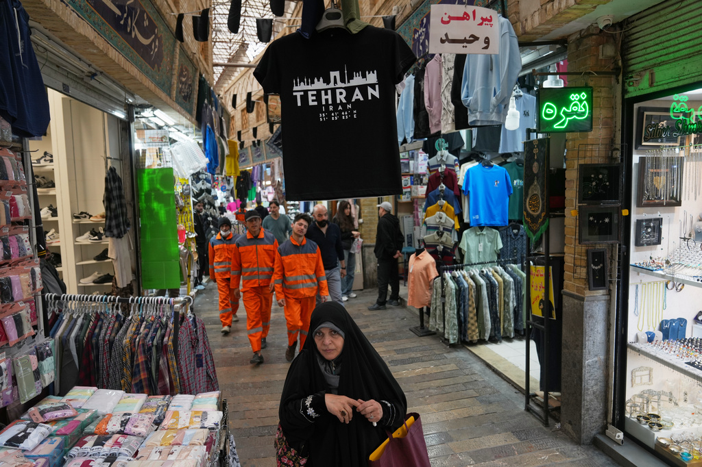 Pedestrians walk through Tajrish Bazaar in Tehran, Iran, Tuesday, April 7, 2026. (AP Photo/Francisco Seco)