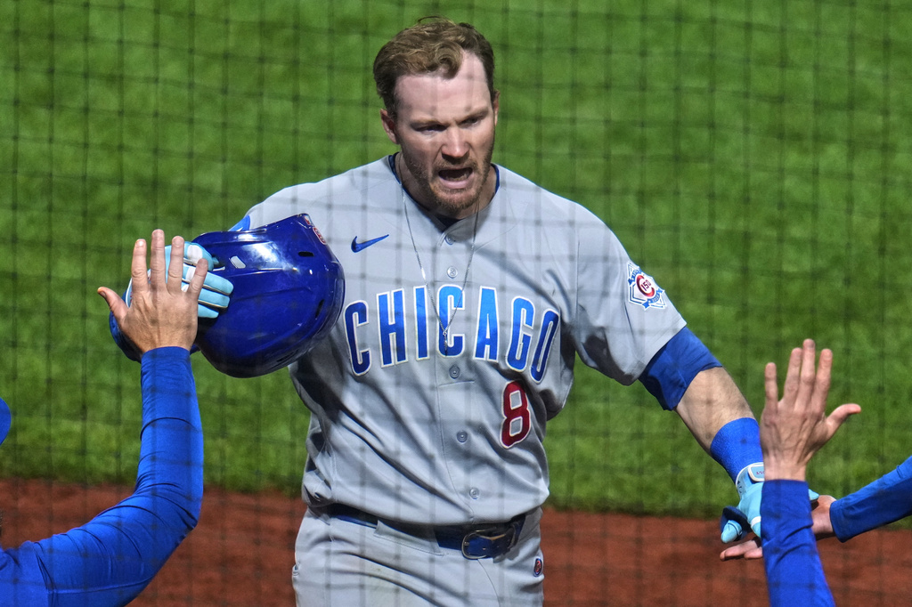 Chicago Cubs' Ian Happ returns to the dugout after hitting a two-run home run off Pittsburgh Pirates pitcher Brandan Bidois during the eighth inning of a baseball game in Pittsburgh, Thursday, May 28, 2026. (AP Photo/Gene J. Puskar)