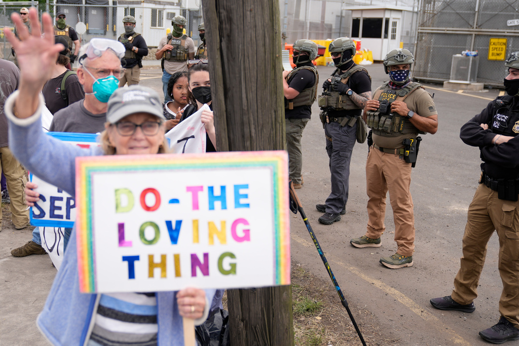 Masked federal agents stand outside the Delaney Hall detention center during a protest against the transfer of detainees on Wednesday, May 27, 2026, in Newark, N.J. (AP Photo/Seth Wenig)