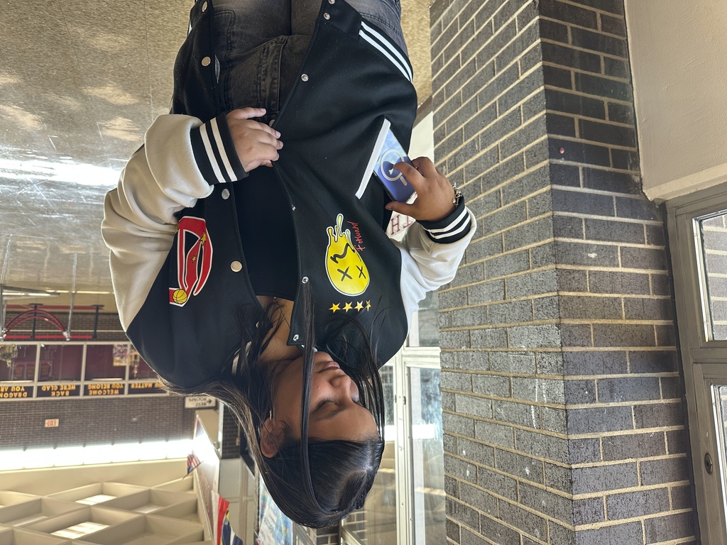 Doss High School student Mia Rivera demonstrates how she puts her phone away before the start of school on Friday, Aug. 15, 2025, in Louisville, Ky. (AP Photo/Dylan Lovan)
