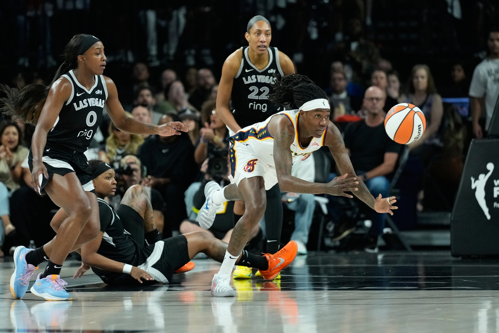 Indiana Fever forward Natasha Howard (6) passes the ball against the Las Vegas Aces during the first half of Game 5 of a WNBA basketball playoff semifinals series Tuesday, Sept. 30, 2025, in Las Vegas. (AP Photo/John Locher)