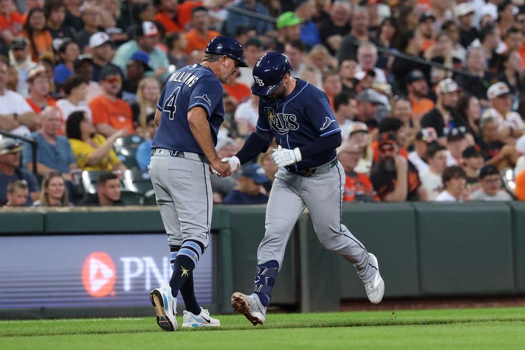 Tampa Bay Rays' Liam Hicks, right, is greeted by third base coach Brady Williams (4) as he runs the bases after hitting a home run off Baltimore Orioles pitcher Brandon Young during the second inning of baseball game in Baltimore, Saturday, Aug. 22, 2026. (AP Photo/Terrance Williams)