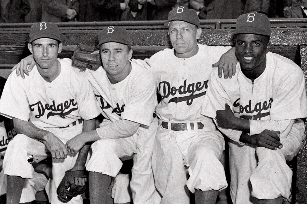 FILE - From left, Brooklyn Dodgers third baseman John Jorgensen, shortstop Pee Wee Reese, second baseman Ed Stanky, and first baseman Jackie Robinson pose before a baseball game against the Boston Braves at Ebbets Field in Brooklyn, N.Y., in this April 15, 1947, file photo. (AP Photo/Harry Harris, File)