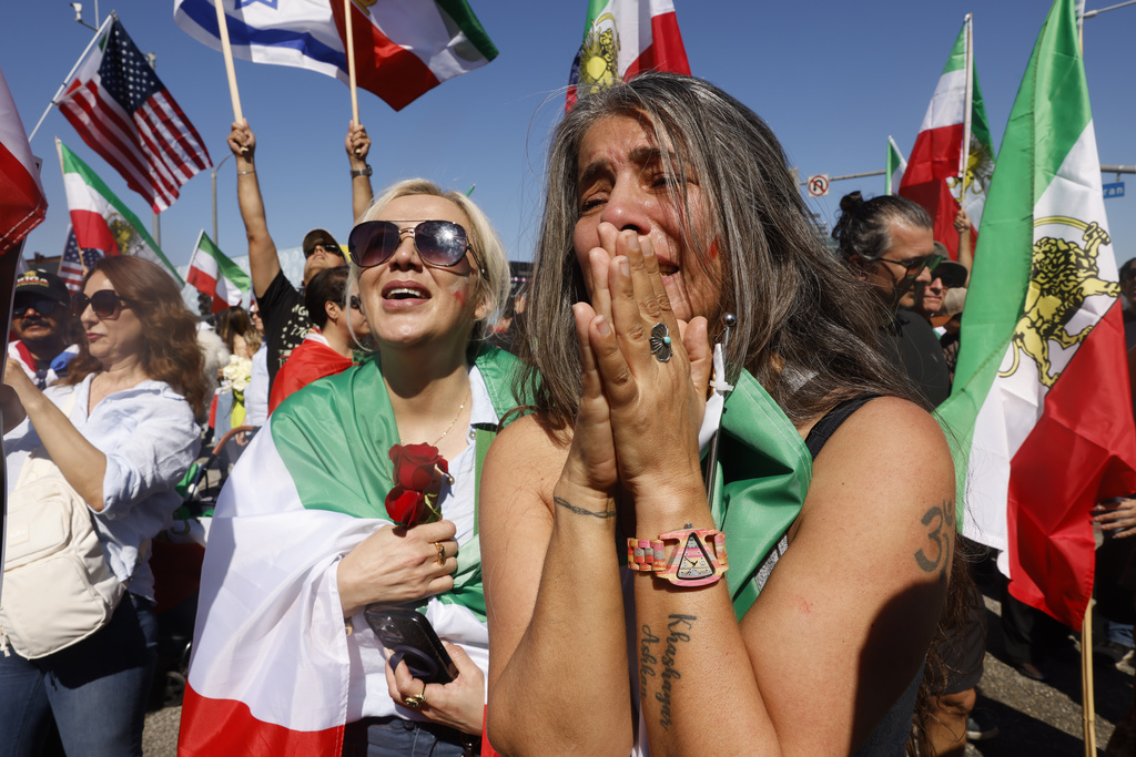 People react during a demonstration in support of the U.S. and Israeli strikes on Iran on Sunday, March 1, 2026, in Los Angeles. (AP Photo/Jill Connelly)