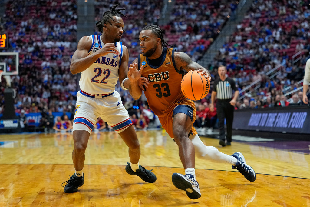 California Baptist guard Martel Williams (33) drives to the basket as Kansas guard Darryn Peterson (22) defends during the second half in the first round of the NCAA college basketball tournament Friday, March 20, 2026, in San Diego. (AP Photo/Mark J. Terrill)