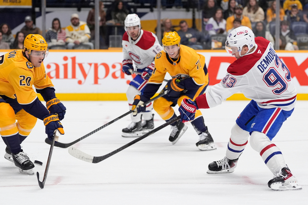 Montreal Canadiens right wing Ivan Demidov (93) shoots the puck past Nashville Predators defenseman Justin Barron (20) during the first period of an NHL hockey game Saturday, March 28, 2026, in Nashville, Tenn. (AP Photo/George Walker IV)