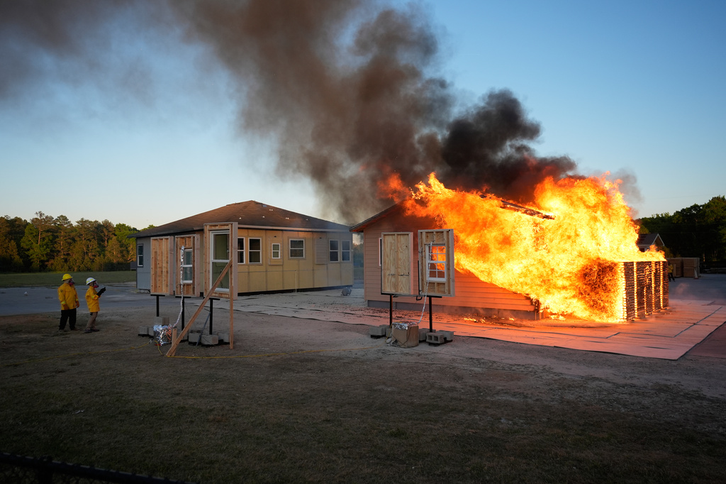 Wildfire researchers watch an accessory dwelling unit burn during an experiment at the Institute for Business & Home Safety center on Thursday, April 16, 2026, in Richburg, S.C. (AP Photo/Erik Verduzco)